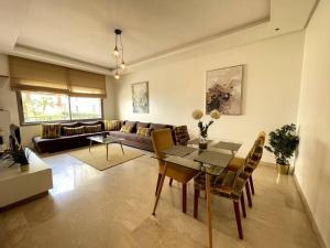 a living room with a table and a couch at 5 Star Apartment Near Airport in Nouaseur