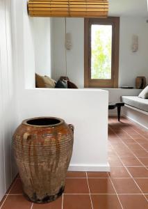 um vaso grande sentado no chão de uma sala em Bergerie casitas suite em Canet-en-Roussillon