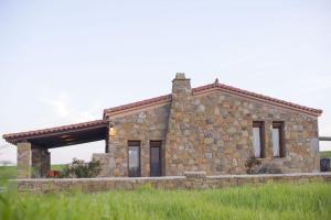 a stone house in the middle of a field at Villa Marina Limnos in Pedhinón