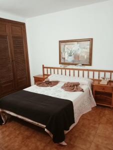 a bedroom with a bed with a black blanket at Apartamentos las Acacias in Puerto del Carmen