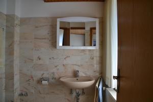 a bathroom with a sink and a mirror at Haus Widder Nr3 in Kopendorf