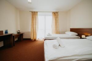 Łóżko lub łóżka w pokoju w obiekcie Noclegi - Apartamenty Żołynianka