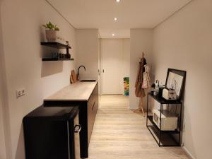 een keuken met een zwart aanrecht en een houten vloer bij Suite Kaiser: Charming City Apartment in Waldshut-Tiengen