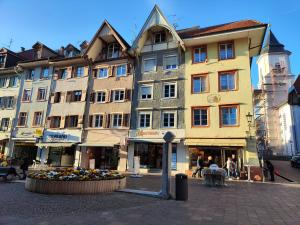 a large building on a street in a city at Suite Kaiser: Charming City Apartment in Waldshut-Tiengen