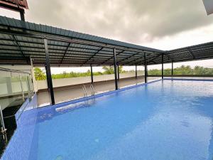 a large blue swimming pool on top of a building at La baga Beach Hotel By Orion Hotels in Calangute