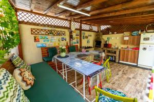 a kitchen with a table and some chairs in it at Casa Amelie Mangalia in Mangalia