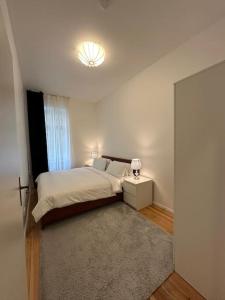 a bedroom with a bed and a large mirror at Modern 2Room Apartment/Neukölln in Berlin