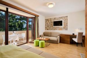 a living room with a couch and a table at Villa Dobravac Wine Estate in Rovinj