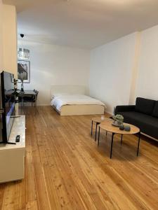 a living room with a bed and a table at Modern 2Room Apartment/Neukölln in Berlin