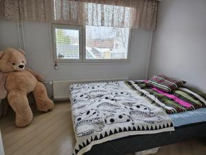 a bedroom with a bed and a teddy bear at Savonlinnan keskusta in Savonlinna