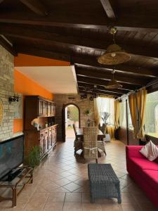 a living room with a couch and a tv at Villa Claudia in Specchiolla 