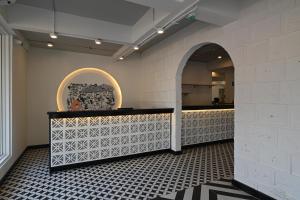 a room with a counter with two mirrors on the wall at Bedzzz Xclusiv Morjim, Goa By Leisure Hotels in Morjim +51 photos