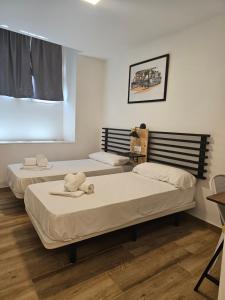 Posteľ alebo postele v izbe v ubytovaní Planeta Cádiz Apartaments
