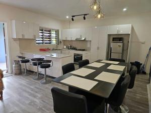 a kitchen with a table and chairs in a room at Moutain View Villa in Pacific Harbour