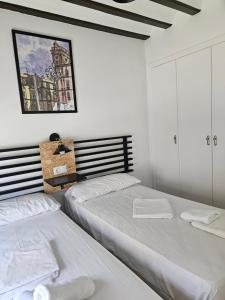 Posteľ alebo postele v izbe v ubytovaní Planeta Cádiz Apartaments