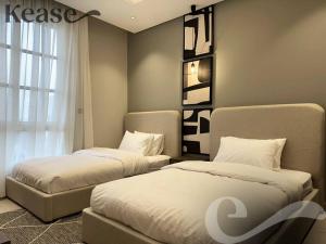 a bedroom with two beds and a window at Kease Malqa D-12 Royal Touch GZ20 in Riyadh