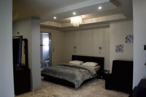 A bed or beds in a room at Minoa Athens Hotel