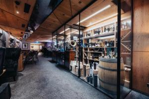 a room with a bar with a bunch of wine bottles at Der Rindererhof in Tux
