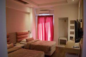 A television and/or entertainment centre at Minoa Athens Hotel