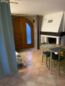 a dining room with a table and a fireplace at Studio ardéchois in Quintenas