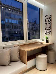 a room with a window with a bench and a desk at Pelagus City - Luxury Suite I in Thessaloniki