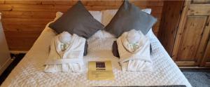 a bed with towels on top of it at Glamping Cabin - Great for Hikers - Breakfast inc! in Swanage