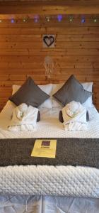 a large bed with towels on top of it at Lavender Cabin on the Jurassic coast in Swanage