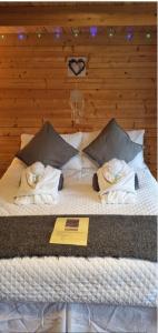 a large bed with towels on top of it at Lavender Cabin on the Jurassic coast in Swanage