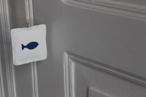 a door with a fish sign on it next to a door at Salamureci Camere in Trapani