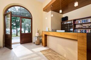 a lobby with a library with a counter and a door at Villa Dobravac Wine Estate in Rovinj +23 photos