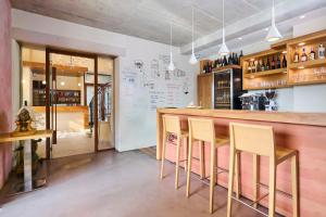 a restaurant with a bar with chairs in it at Villa Dobravac Wine Estate in Rovinj