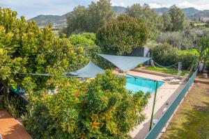 an aerial view of a house with trees and a swimming pool at Spiti Damianos Villa Beachfront in Pomos