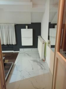 DAMI 2 في توزلا: غرفة ذات أرضية رخام مع ثلاجة بيضاء