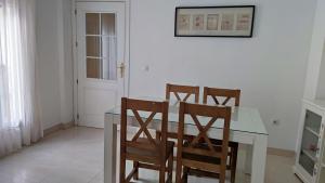 a dining room with a table and four chairs at Tahona in Carmona