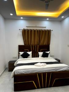 a bedroom with a large bed with a curtain at Hotel Trending Stay in New Delhi