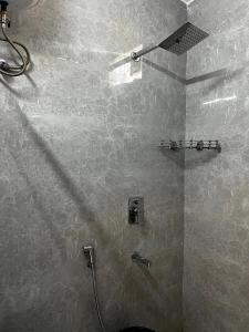 a bathroom with a shower with a glass door at Hotel Trending Stay in New Delhi +60 photos