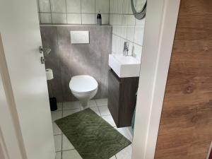uma pequena casa de banho com WC e lavatório em Ferienwohnung -Schwalbe em Attendorn