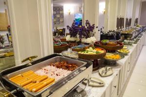 a buffet line with many different types of food at At Pingnakorn Hotel in Chiang Mai
