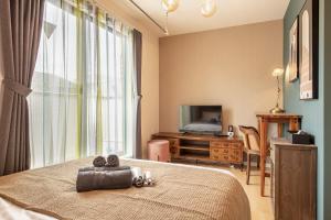a bedroom with a bed with a teddy bear on it at Felice Nishi-Shinjuku in Tokyo