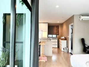 a kitchen and living room with a large window at Free pick up / Stunning Luxury Family Home 3B3B in Bangkok