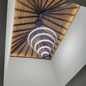 a spiral light fixture hanging from a ceiling at SUNNYRENT. Guest villa Dreamland in Ungasan