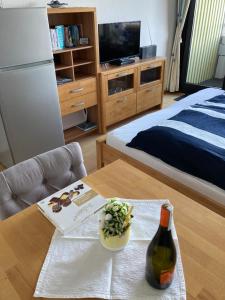 a bottle of wine on a table in a room at Ferienwohnung Schlosser in Kiel