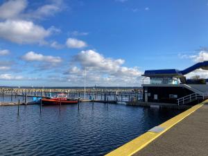 a boat is docked at a dock in the water at Ferienwohnung Schlosser in Kiel