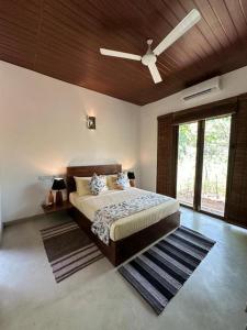 a bedroom with a bed and a ceiling fan at Turtle Pond Wilpattu in Wilpattu