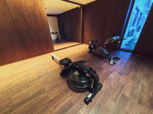 a room with a exercise bike and a mirror at The Purple Horse in Beijing