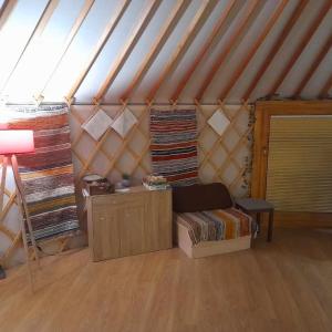 a room with a bed and a table in a yurt at Szent Márton Jurtaszállás Zalakaros közelében in Nagyrécse