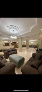 a large living room with couches and a chandelier at الديوان النجدي للشقق المخدومة in Ukaz