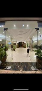 a large lobby with a large glass wall in a building at الديوان النجدي للشقق المخدومة in Ukaz