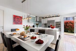 a kitchen with a white table with fruit on it at Villa Dolce Vita With Private Pool - Happy Rentals in Lugano
