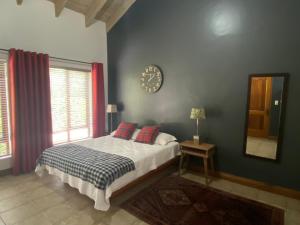 a bedroom with a bed and a clock on the wall at BLessing at Lynnwood in Pretoria